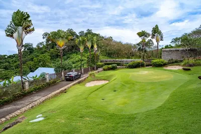 an aerial view of a golf course with palm trees at Royal Legacy Golf Private Villa in Rawai Beach