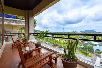 a balcony with a table and chairs and plants at Royal Legacy Golf Private Villa in Rawai Beach