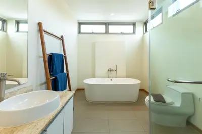 a bathroom with a tub and a sink and a toilet at 3BR Pool Villa near Rawai Beach - Villa Kamana in Rawai Beach