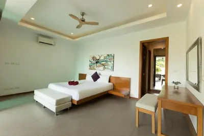 a bedroom with a bed and a table and a desk at 3BR Pool Villa near Rawai Beach - Villa Kamana in Rawai Beach