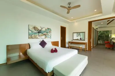 a bedroom with a large white bed and a desk at 3BR Pool Villa near Rawai Beach - Villa Kamana in Rawai Beach