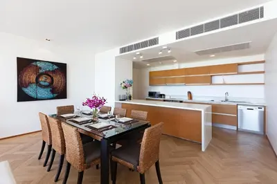 a kitchen and dining room with a table and chairs at The Heights C3 SeaView 2 BR, 5min to Kata Beach in Ban Karon