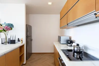 a kitchen with a stove and a refrigerator at The Heights C3 SeaView 2 BR, 5min to Kata Beach in Ban Karon
