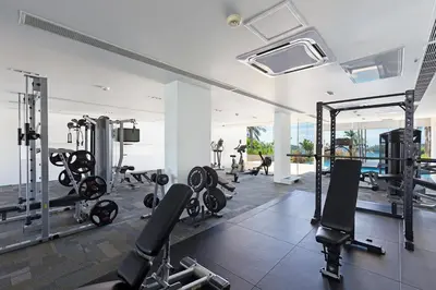 a gym with several treadmills and cardio machines at The Heights C3 SeaView 2 BR, 5min to Kata Beach in Ban Karon