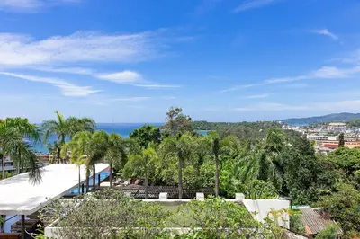 a view of the ocean from a resort with palm trees at The Heights C3 SeaView 2 BR, 5min to Kata Beach in Ban Karon