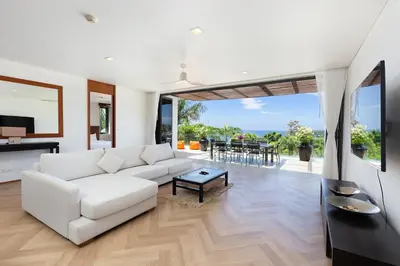 a living room with a white couch and a table at The Heights C3 SeaView 2 BR, 5min to Kata Beach in Ban Karon