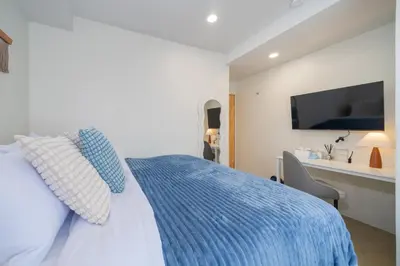 a bedroom with a bed with a blue comforter at Spacious 8 Bedroom 20 Person Near Patong Beach in Patong Beach