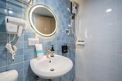 a blue tiled bathroom with a sink and a mirror at Spacious 8 Bedroom 20 Person Near Patong Beach in Patong Beach