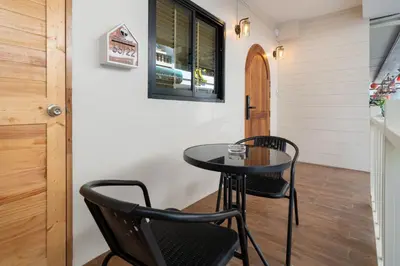 a small black table and two chairs in a room at Spacious 8 Bedroom 20 Person Near Patong Beach in Patong Beach
