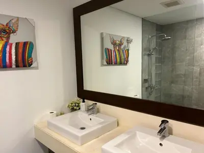 a bathroom with a sink and a large mirror at Bangtao Beach Gardens 2 bedroom villa near Surin beach in Ban Lum Fuang