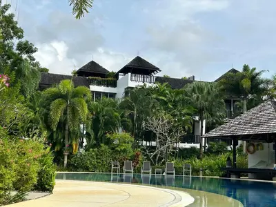 a resort with a swimming pool in front of a building at Bangtao Beach Gardens 2 bedroom villa near Surin beach in Ban Lum Fuang