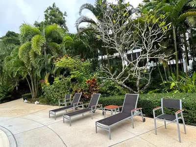 a group of chairs and a table in a courtyard at Bangtao Beach Gardens 2 bedroom villa near Surin beach in Ban Lum Fuang