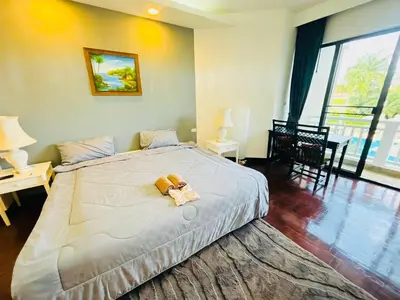 a bedroom with a bed with a teddy bear on it at Allamanda 2 lake side pad in the heart of Laguna in Laguna Phuket