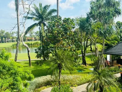 a view of a park with palm trees and a pond at Allamanda 2 lake side pad in the heart of Laguna in Laguna Phuket