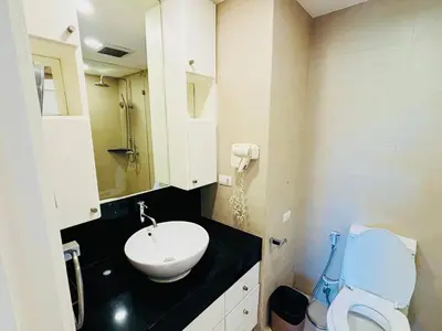 a bathroom with a white sink and a toilet at Allamanda 2 lake side pad in the heart of Laguna in Laguna Phuket