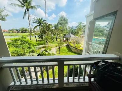 a balcony with a view of a yard at Allamanda 2 lake side pad in the heart of Laguna in Laguna Phuket