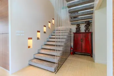 a staircase in a home with a metal railing at 10 bed,12 bath, 3 pools,zip-line,sauna, Ocean view in Ban Saiyuan (1)