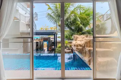 a view of a swimming pool from a hotel window at 10 bed,12 bath, 3 pools,zip-line,sauna, Ocean view in Ban Saiyuan (1)