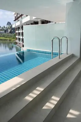 a swimming pool in a building with water at Апартаменты в Angsana, Банг Тао in Laguna Phuket
