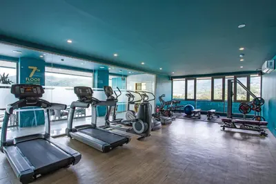 a gym with several treadmills and machines in a room at Oceana A32 1 BR Sea View - Kamala Beach in Kamala Beach