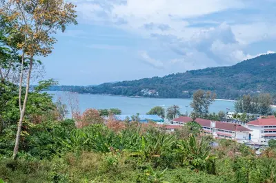 a view of a body of water with buildings and trees at Oceana A32 1 BR Sea View - Kamala Beach in Kamala Beach