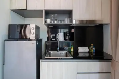 a small kitchen with a sink and a refrigerator at Seaview 1BR Apt Oceana C36 near Kamala Beach in Kamala Beach