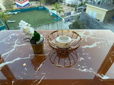 a table with two cups and a plant on it at 1BR Panoramic Mountain View Walk to Beach by Renttini in Kamala Beach