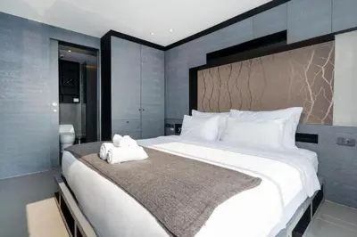 a bedroom with a large white bed in a room at Relax at CTG L702-3 - Kamala Health Complex in Kamala Beach