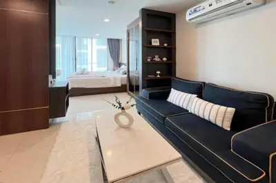 a living room with a couch and a bed at Beach and Party in Patong with 1BR Apt - Viva B402 in Patong Beach