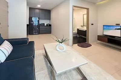 a living room with a couch and a table at Beach and Party in Patong with 1BR Apt - Viva B402 in Patong Beach