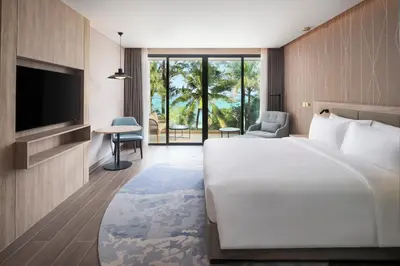 a hotel room with a large bed and a television at Radisson Blu Resort, Phuket Mai Khao Beach in Mai Khao Beach