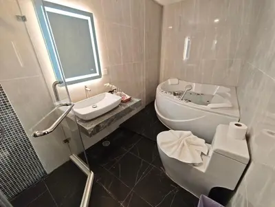 a white bathroom with a sink and a toilet at JJame Pool Villa Patong in Patong Beach