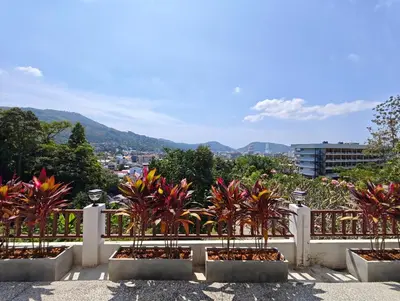 a white fence with some plants in pots at JJame Pool Villa Patong in Patong Beach