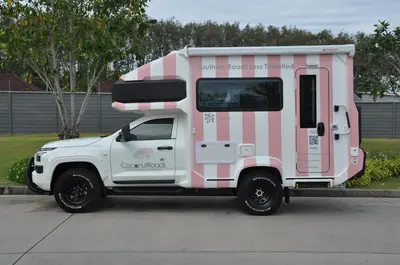 a pink and white truck parked in a parking lot at CoconutRoads Self Drive Motorhome in Phuket