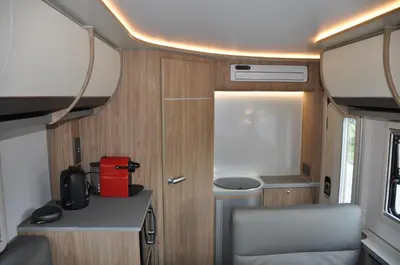 an rv with a table and a chair in it at CoconutRoads Self Drive Motorhome in Phuket