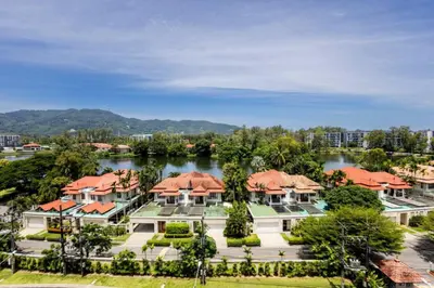 an aerial view of a large house with a lake at Premium apartment in Laguna in Thalang