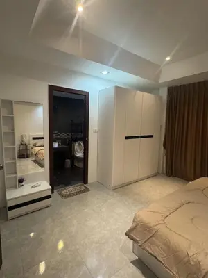 a bedroom with a bed and a large mirror at Kamala Cozy Townhouse in Kamala Beach