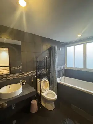 a bathroom with a sink and a toilet and a tub at Kamala Cozy Townhouse in Kamala Beach