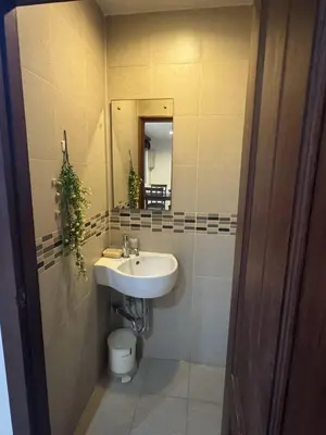 a bathroom with a sink and a toilet and a mirror at Kamala Cozy Townhouse in Kamala Beach
