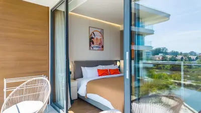 a bedroom with a bed and a balcony at Apartment 50 metres from the sea on Bangtao beach in Layan Beach