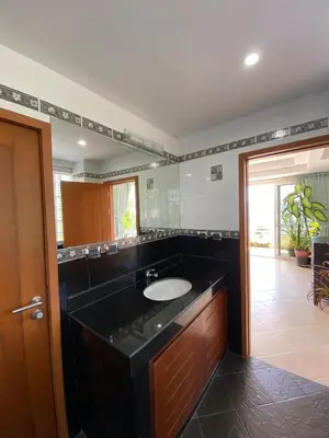 a bathroom with a sink and a large mirror at Andaman hill pool Seaview three bedroom in Patong Beach