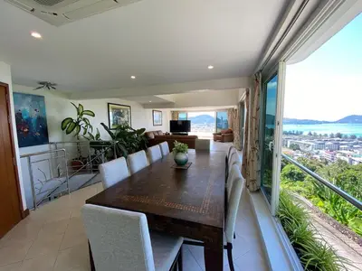 a dining room with a table and chairs at Andaman hill pool Seaview three bedroom in Patong Beach