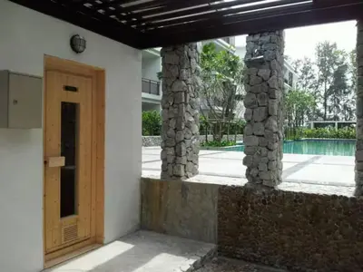 a entrance to a house with a wooden door at Beach Front Condo on Rawai Beach in Rawai Beach