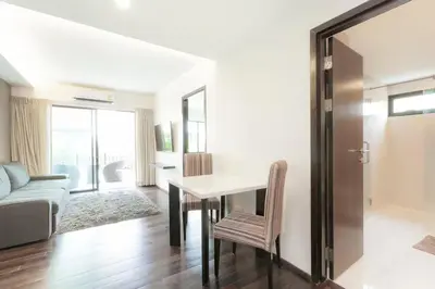a living room with a table and a couch at Beach Front Condo on Rawai Beach in Rawai Beach