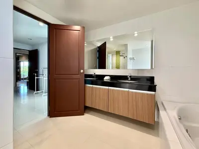 a bathroom with a sink and a mirror and a tub at Bangtao Tropical Residence by Villacarte in Ban Lum Fuang