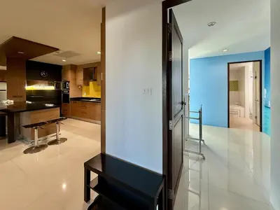 a living room with a mirror and a kitchen at Bangtao Tropical Residence by Villacarte in Ban Lum Fuang
