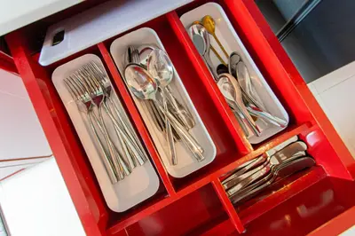 a bunch of utensils in a red box at Baan Sino Phuket in Ban Phlu Yai
