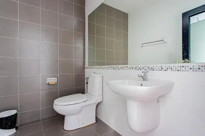 a bathroom with a toilet and a sink at Baan Sino Phuket in Ban Phlu Yai