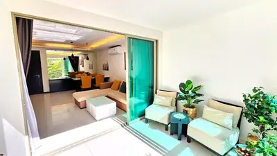 a living room with a couch and a table at Phuket KAMALA Apartment in Phuket Town