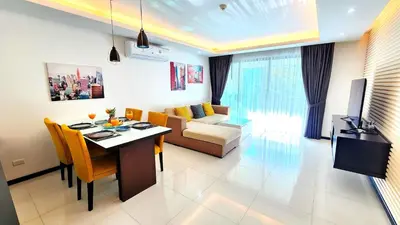 a living room with a table and a couch at Phuket KAMALA Apartment in Phuket Town